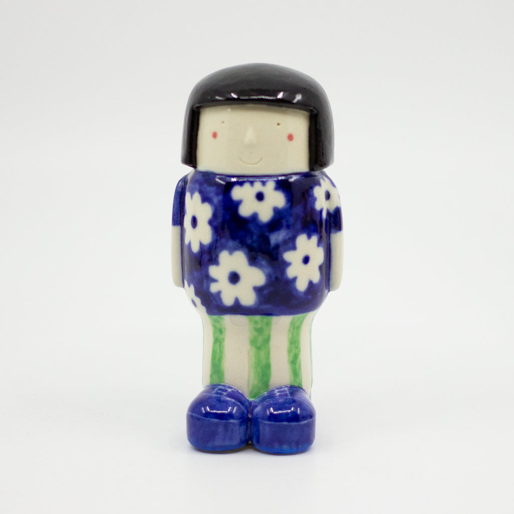 A frontview of the girl figurine number 5 with daisy pattern. 