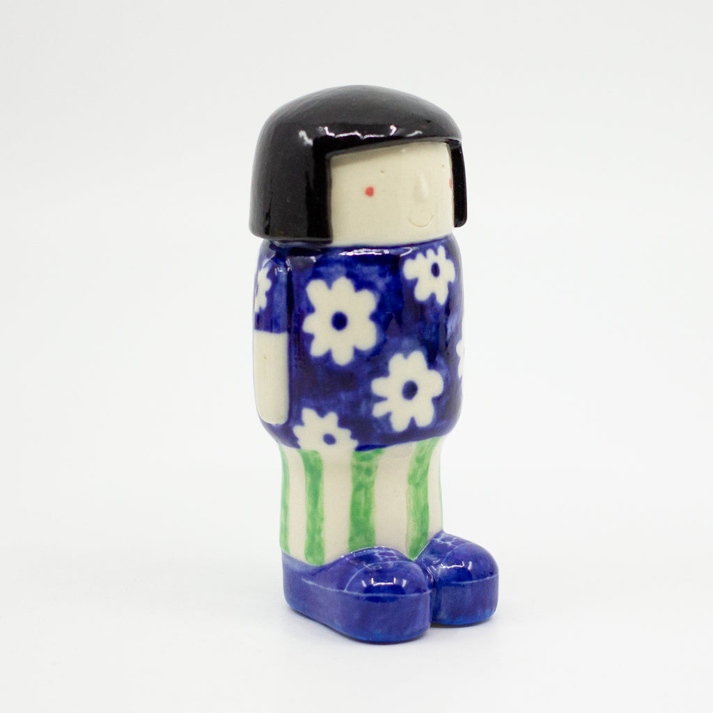 A Side view of the girl figurine number 5 with daisy pattern. 