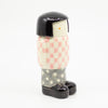 Girl figurine number 6, otherside view, with chequered pattern. 