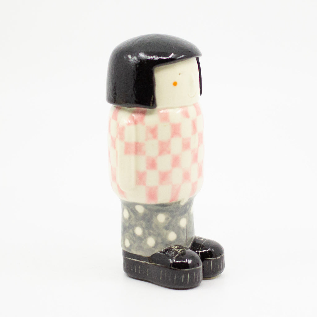 Girl figurine number 6, otherside view, with chequered pattern. 
