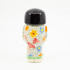 A Back view of girl figurine number 8, with floral pattern. 