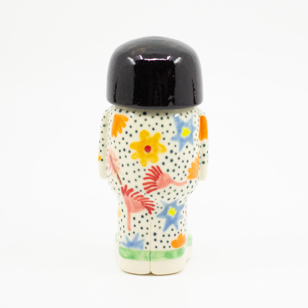 A Back view of girl figurine number 8, with floral pattern. 