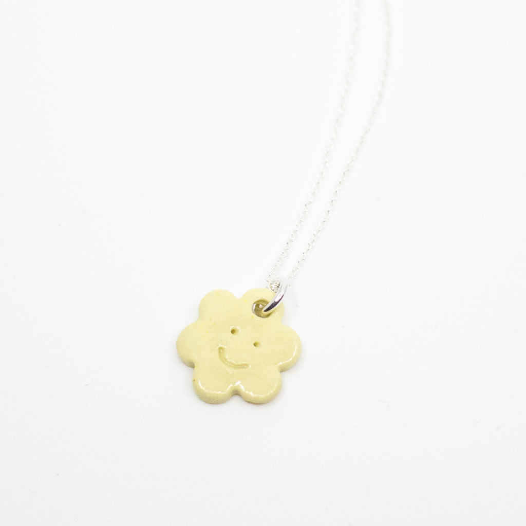 Necklace with a yellow pendant on a white background