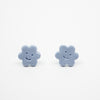 Pair of blue flower-shaped earrings on a white background