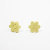 Pair of yellow flower-shaped earrings on a white background