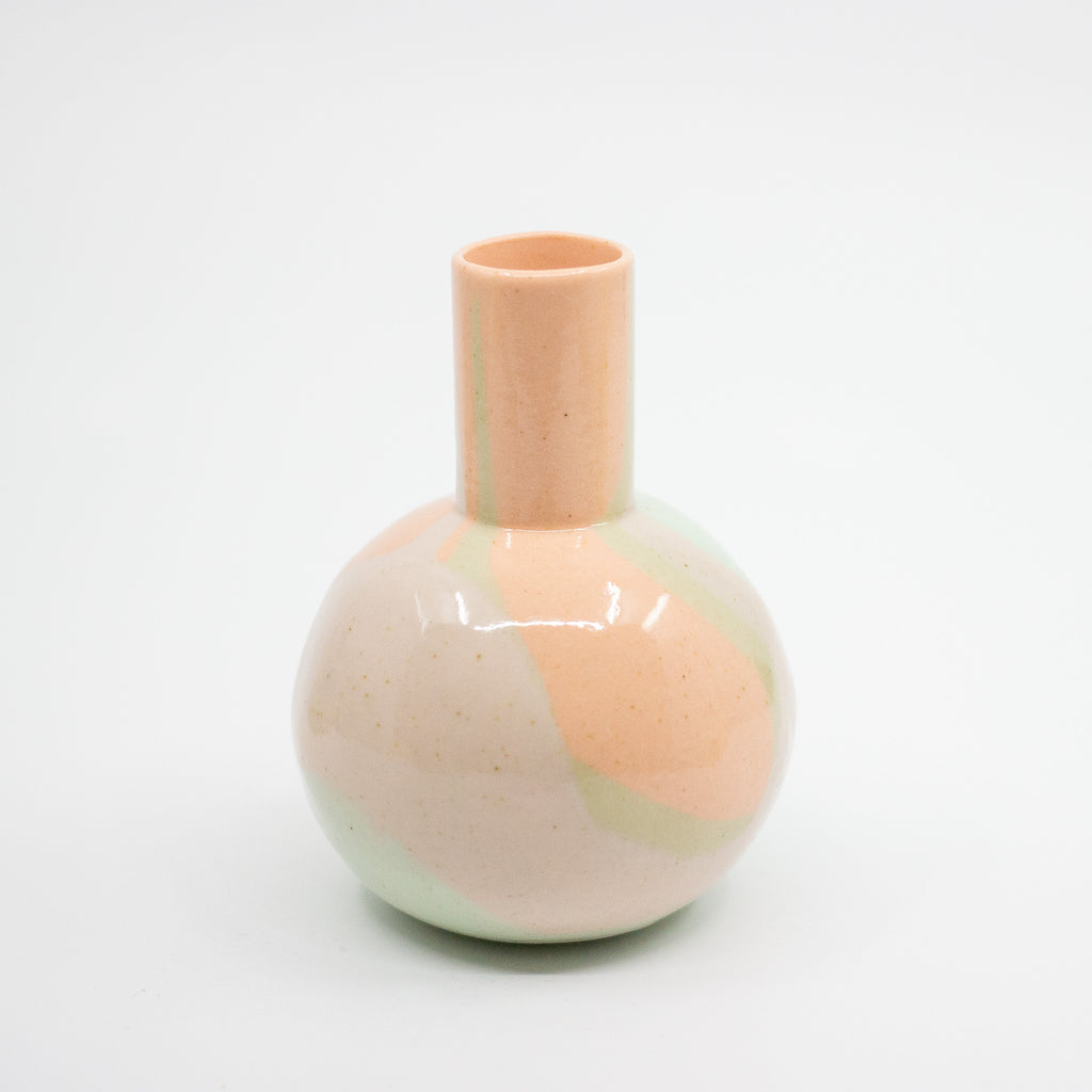 Ceramic vase with pastel swirl design on a light gray background
