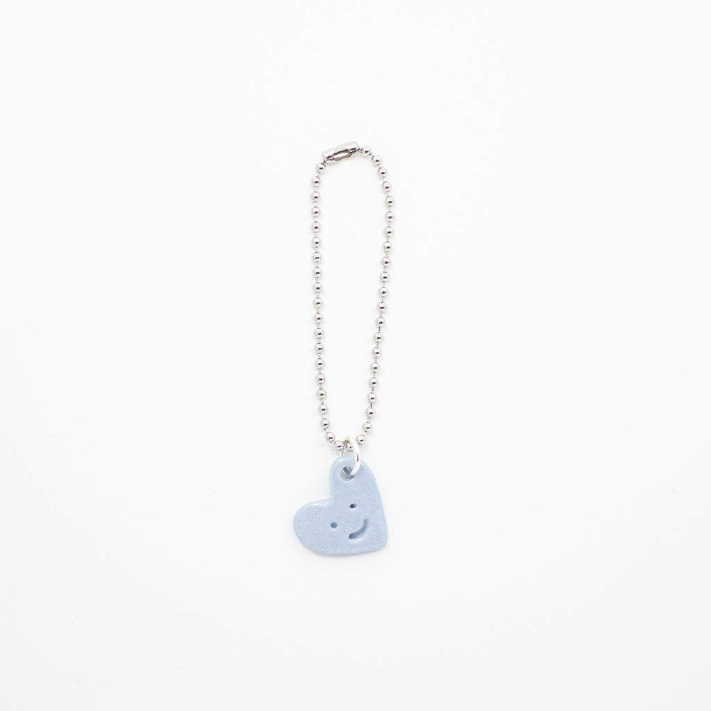 Keychain with a blue heart-shaped charm on a white background