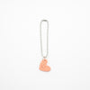 Keychain with a pink heart-shaped charm on a white background