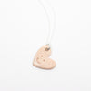 Heart-shaped pendant on a white background