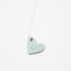 Sky Blue heart-shaped pendant on a white background