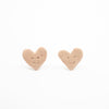 Heart-shaped earrings with smiley faces on a white background