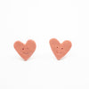 Heart-shaped earrings with smiley faces on a white background