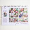 A spiral-bound calendar from Nanan Studio is shown against a plain white wall. The page features a portrait photo of a woman, the text 'Artist behind the scene,' and a grid of colourful illustrated artworks.