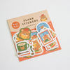 A package of cute bear-themed flake stickers on a white background. The packaging is light brown with orange accents and reads 'FLAKE STICKERS - Home Bear -'.