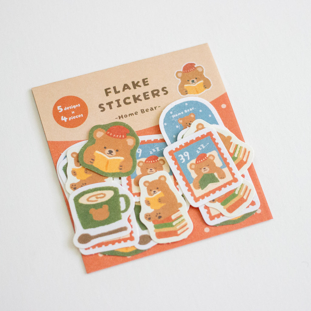 A package of cute bear-themed flake stickers on a white background. The packaging is light brown with orange accents and reads 'FLAKE STICKERS - Home Bear -'.