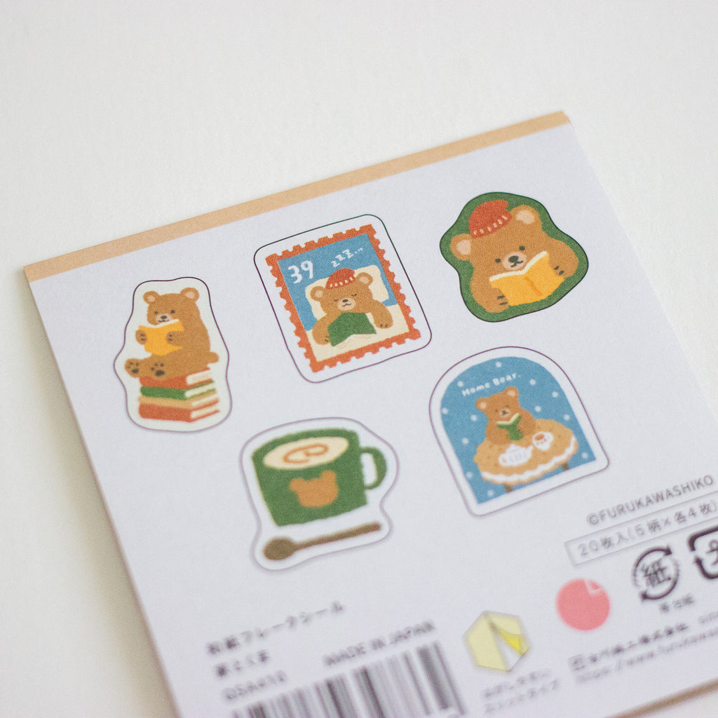 A sheet of cute die-cut sticker sheets featuring cartoon bears in cozy scenes, photographed on a clean white background.