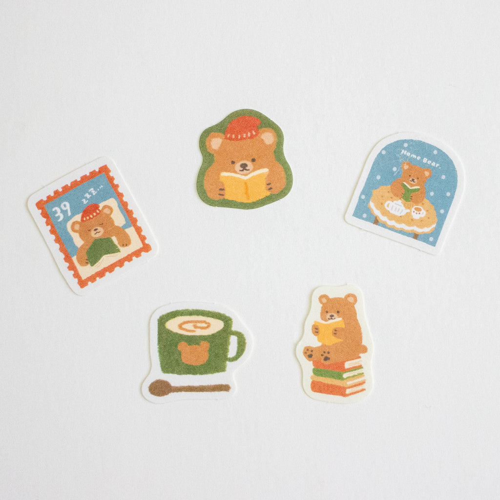 Five cute cartoon bear stickers with winter and reading-themed designs, arranged on a plain white background.