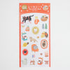 A sheet of cute cat-themed foil stickers with Japanese text at the top, featuring illustrations of cats in cosy home and fashion settings on a white background.