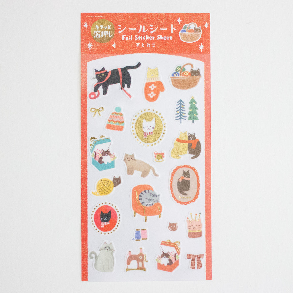 A sheet of cute cat-themed foil stickers with Japanese text at the top, featuring illustrations of cats in cosy home and fashion settings on a white background.