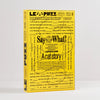 A yellow word puzzle book titled 'LE PUZZ A Cat story' with black text and illustrations, standing upright against a light grey background.