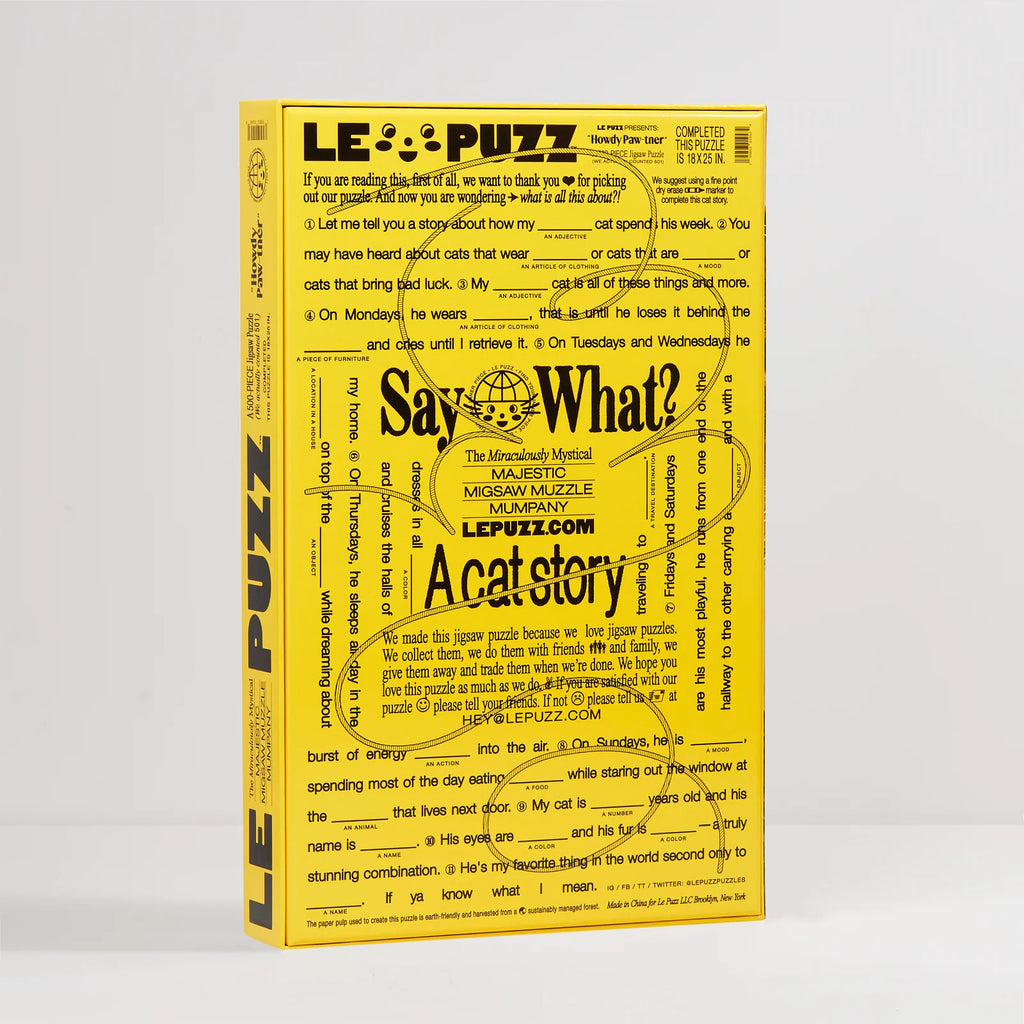 A yellow word puzzle book titled 'LE PUZZ A Cat story' with black text and illustrations, standing upright against a light grey background.