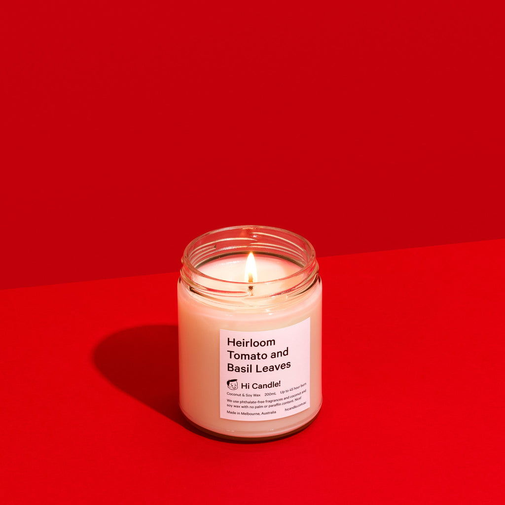 Candle in a glass jar on a red background