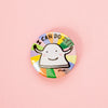 A round pinback button badge featuring a cartoon sheep character with the text 'I CAN DO IT!' and a small 'shuh.' signature, set against a colourful rainbow-striped background on a soft pink backdrop.