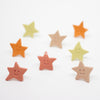 Colorful star-shaped Earrings with smiley faces on a white background