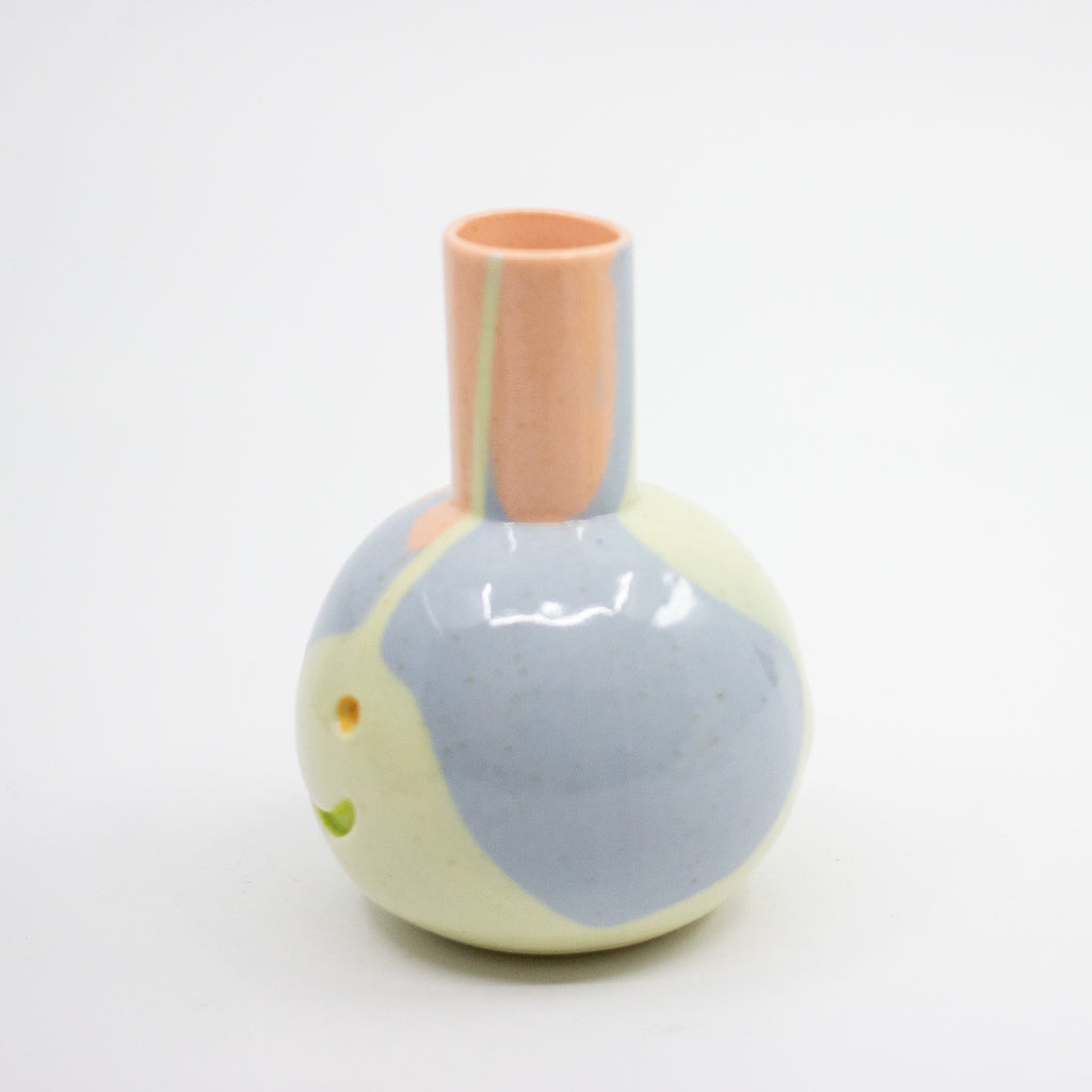 Small ceramic vase with a pastel design on a white background