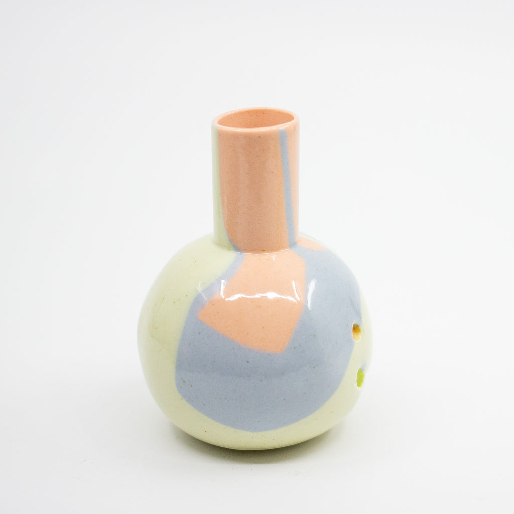 Ceramic vase with pastel pink and gray design on a white background