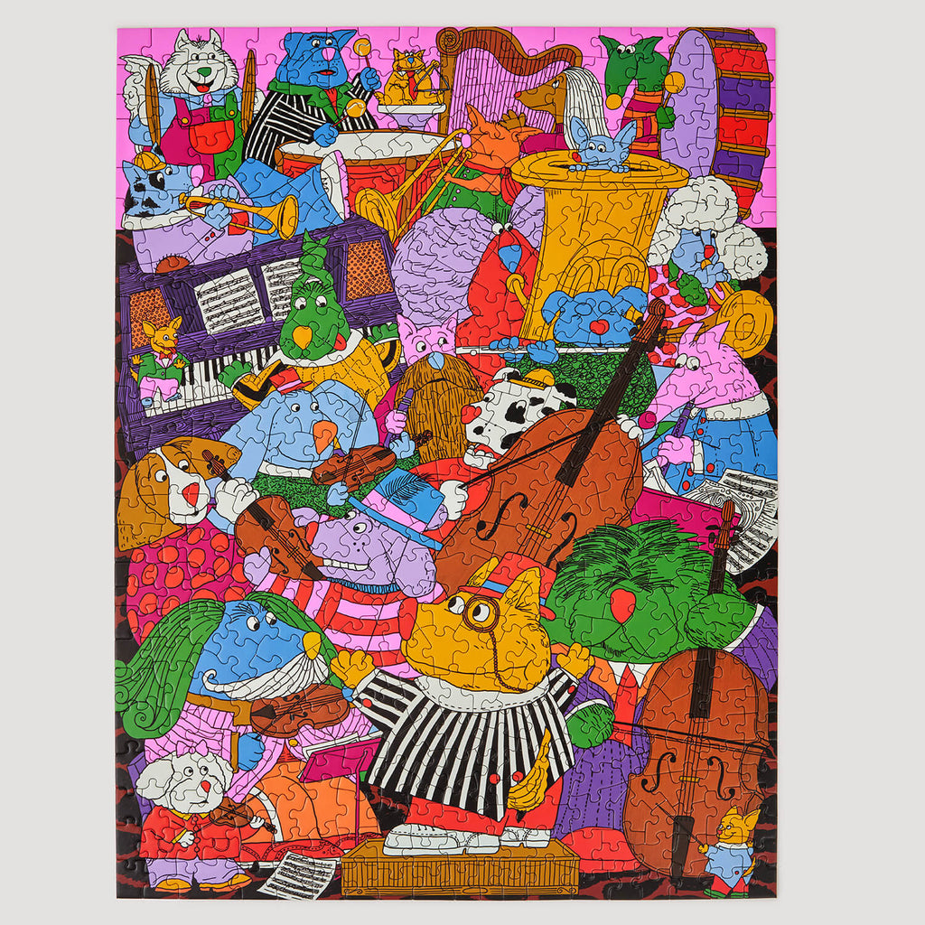 A finished puzzle featuring highly detailed, colourful cartoon illustration on the front showing many characters and objects photographed on a clean light grey background.