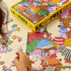 Person assembling a puzzle of a colour illustrations.