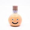 Front view of the Kaori vase. Light orange colour, blue smile, multicoloured spout.