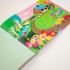 Colourful book with farm illustration on a white background