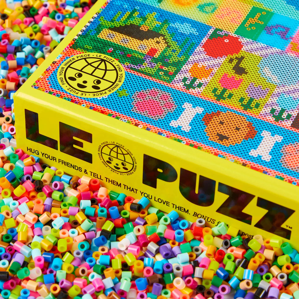 LE PUZZ box with colourful beads scattered around