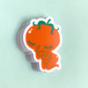 Sticker of a cartoon-like orange character with green hair on a light mint background