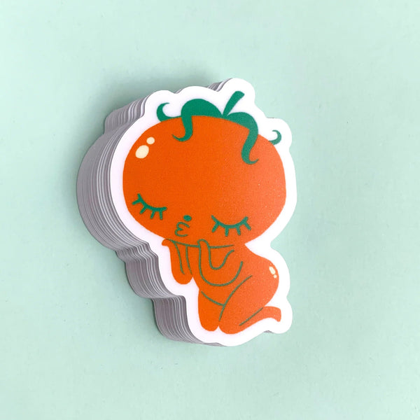 Sticker of a cartoon-like orange character with green hair on a light mint background