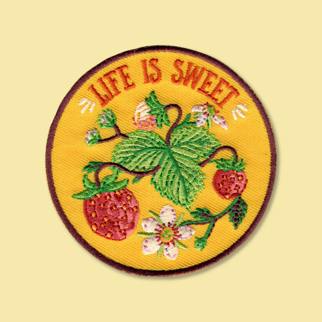 Embroidered patch with 'Life is Sweet' text and strawberry design on a yellow background