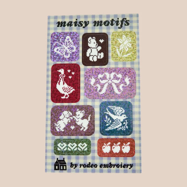 Embroidery pattern book titled 'maisy motifs' by rodeo embroidery with colourful designs on a checkered background.