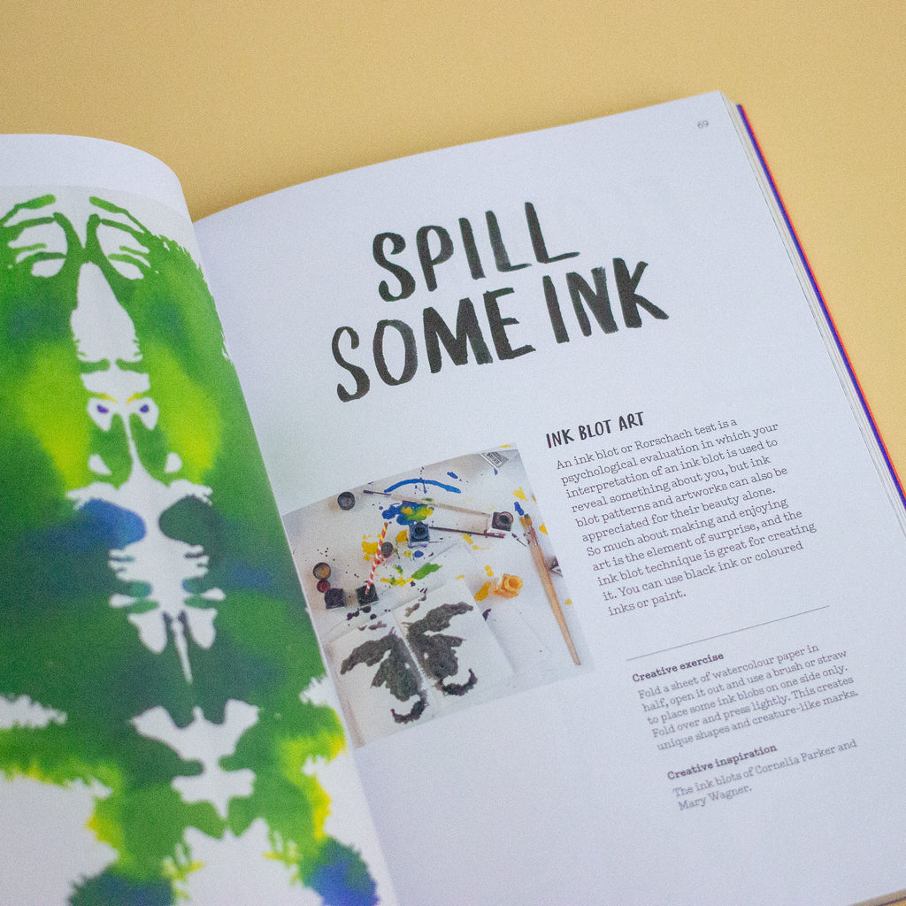 Book with writing and pictures of ink art on a yellow background