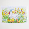 A watercolour art print depicting a mother duck wearing a blue bonnet with her four yellow ducklings in a vibrant field of yellow, purple, and white wildflowers, shown on a white paper sheet against a light background.