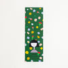 A rectangular green bookmark featuring a colourful floral pattern and a cartoon girl illustration near the bottom, with the text 'shuh. printed in australia' and 'shuhlee.com'.