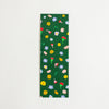 A rectangular dark green bookmark, featuring a colourful pattern of small flowers displayed flat against a light off-white background.