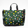 Front view of the meadow easy bag. Multicoloured flowers on a meadow green background.