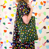 A side view of the meadow linen tote being carried by a model on their shoulder. Illustrated flowers on a meadow green 