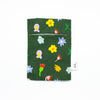 Front view of the Meadow pocket tissue holder. Illustrated wildflowers on a meadow green background