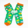 Front view of the Meadown socks. Green background, multicoloured wildflowers, and orange toe with mint heel. 