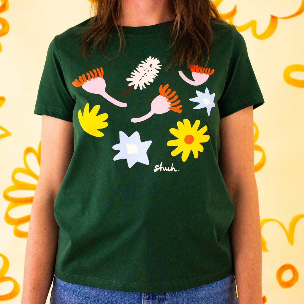 A second Front view of the meadow tee, showing lower hemline. Green coloured tee with printed native flowers.