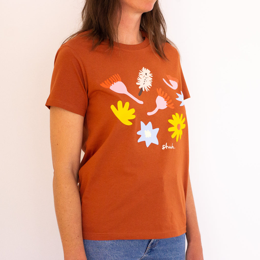 Side view of the meadow tee. Copper coloured tee with printed native flowers.