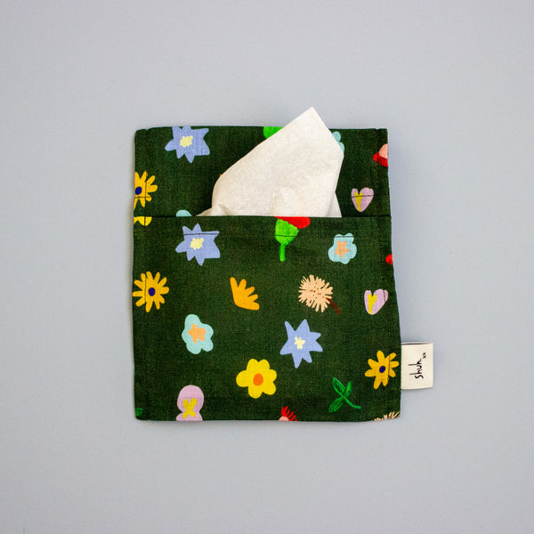 Floral-patterned tissue holder with tissues on a grey background